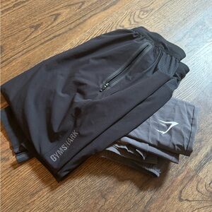 Two pairs of Gymshark men’s drawstring joggers with zippered leg-both included